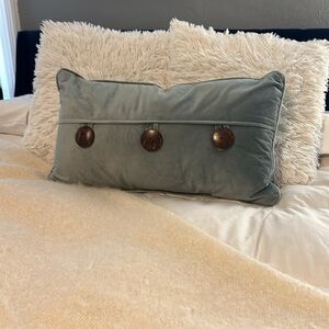 Sage green throw pillow with oversized button detail